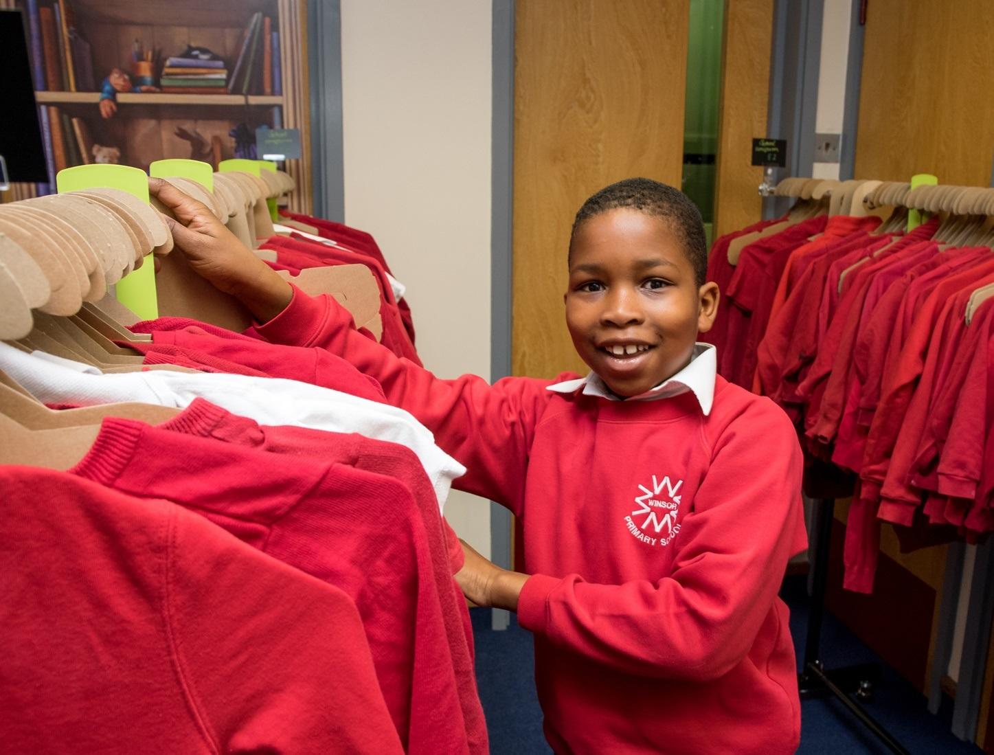 A young student stood in a uniform swap shop.